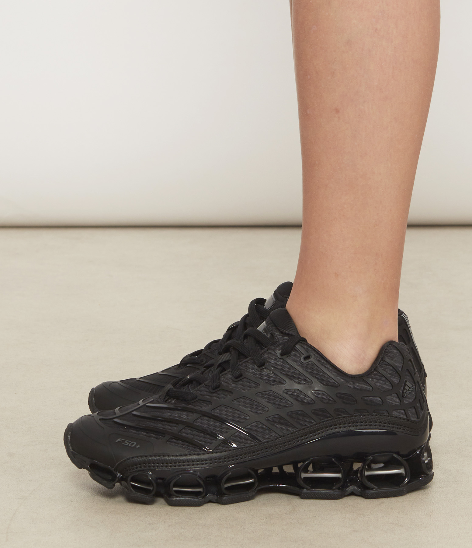 Megaride F50 trainers in Core Black/Core Black/Iron Met.